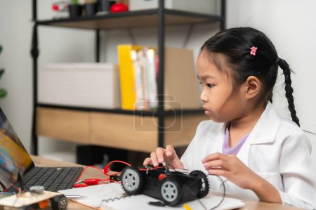 Photo for Asian littlle girl constructing and coding robot at STEM class,Fixing and repair mechanic toy car - Royalty Free Image