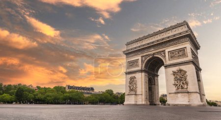 Photo for Famous Arc de Triomphe against nice blue sky Arc de Triomphe monument at at the western end of the Champs-elysees road in Paris, France - Royalty Free Image