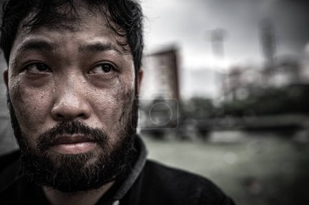 Photo for Asian man is homeless at the side road. A stranger has to live on the road alone because he has no family. - Royalty Free Image
