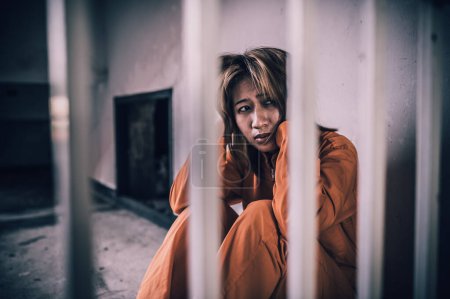 Photo for Portrait of woman desperate to catch the iron prison,prisoner concept, thailand people. Hope to be free. If the violate the law would be arrested and jailed. - Royalty Free Image
