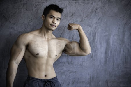 Photo for Portrait of asian man big muscle at the gym. Thailand people. Workout for good healthy. Body weight training. Fitness at the gym concept - Royalty Free Image
