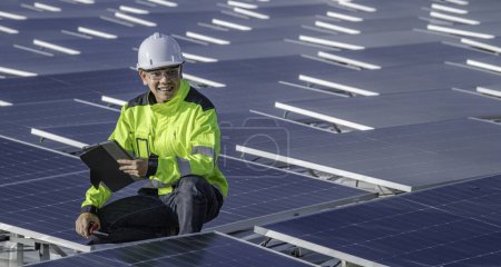 Photo for Asian engineer working at Floating solar power plant. Renewable energy. Technician and investor solar panels checking the panels at solar energy installation - Royalty Free Image