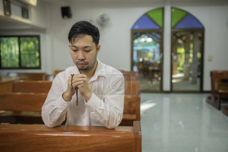 Photo for Christian man asking for blessings from God. Asian man praying to Jesus Christ - Royalty Free Image