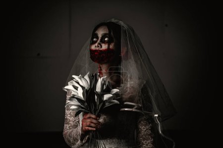 Photo for Halloween festival concept. Asian woman makeup ghost face. Bride zombie charactor. Horror movie wallpaper or poster - Royalty Free Image