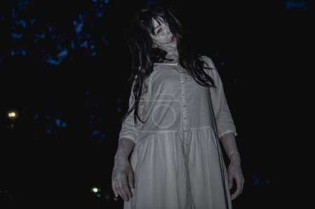 Photo for Portrait of asian woman make up ghost face with blood. Horror scene. Scary background. Halloween poster. Thailand people - Royalty Free Image