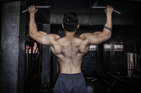 Photo for Portrait of asian man big muscle at the gym. Thailand people. Workout for good healthy. Body weight training. Fitness at the gym concept. Asian man exercise chest muscle workout - Royalty Free Image