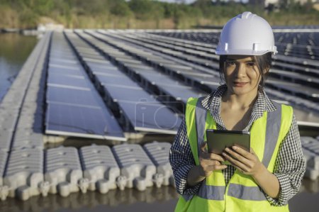 Photo for Asian engineer working at Floating solar farm. Renewable energy. Technician and investor solar panel checking the panels at solar energy installation - Royalty Free Image