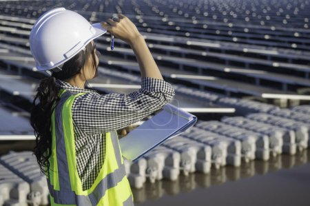 Photo for Asian engineer working at Floating solar farm. Renewable energy. Technician and investor solar panel checking the panels at solar energy installation - Royalty Free Image