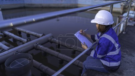 Photo for Environmental engineer work at wastewater treatment plant. Water supply engineering working at Water recycling plant for reuse. Check the amount of chlorine in the water to be within the criteria. - Royalty Free Image