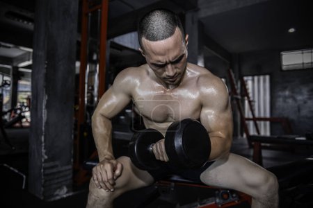 Photo for Portrait of asian man big muscle at the gym. Thailand people. Workout for good healthy. Body weight training. Fitness at the gym concept. Lift up barbell - Royalty Free Image