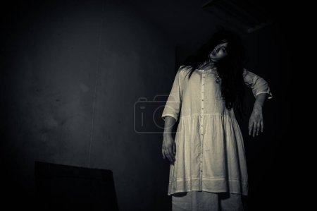 Photo for Portrait of asian woman make up ghost. Scary horror scene for background. Halloween festival concept. Ghost movies poster, angry spirit in the apartment - Royalty Free Image