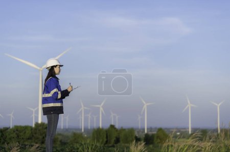 Foto de Ingeniero trabajando y sosteniendo el informe en el parque eólico Power Generator Station en la montaña. Tailandia personas - Imagen libre de derechos