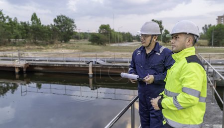 Téléchargez les photos : Ingénieurs de l'environnement travaillent dans les usines de traitement des eaux usées, Ingénierie de l'approvisionnement en eau travaillant à l'usine de recyclage de l'eau pour la réutilisation, Techniciens et ingénieurs discutent travailler ensemble. - en image libre de droit