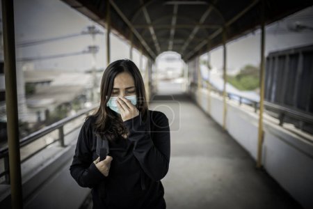 Photo for Asian traveler woman wear mask for protect coronavirus. Thai woman wearing face mask respiratory protect and filter pm2.5 (particulate matter) - Royalty Free Image
