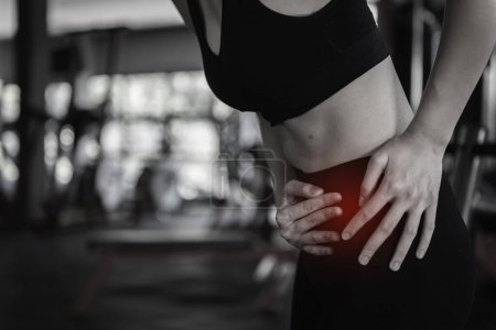 Photo for Asian slim woman play fitness at the gym. She pain from exercise - Royalty Free Image