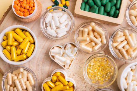 Different nutritional supplements, minerals and vitamins such as vitamin d3 softgels capsules, vitamin C, B, A, magnesium, lactase capsules, zinc, calcium, probiotics in jars to make better health.