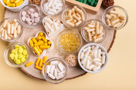 Different nutritional supplements, minerals and vitamins such as vitamin d3 softgels capsules, vitamin C, B, A, magnesium, lactase capsules, zinc, calcium, probiotics in jars to make better health.