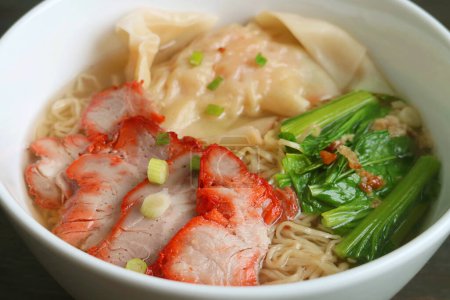 Photo for Mouthwatering Chinese Roasted Pork Egg Noodles and Wontons Soup with Vegetables - Royalty Free Image