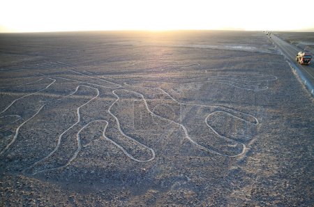 Photo for Amazing massive ancient geoglyphs of Nazca lines called Arbol (tree) in the evening sunlight, view from the observation tower at Nazca desert, Ica region, Peru - Royalty Free Image