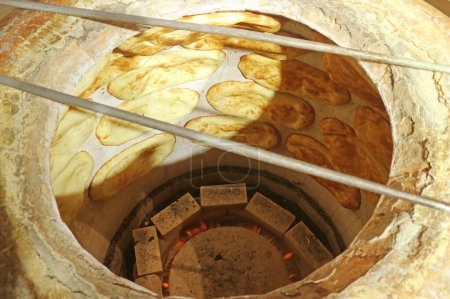 Photo for Group of Armenian traditional breads being baked in a modern gas tonir oven - Royalty Free Image