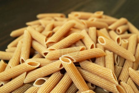 Pile of Uncooked Dried Whole Wheat Penne Rigate Pasta