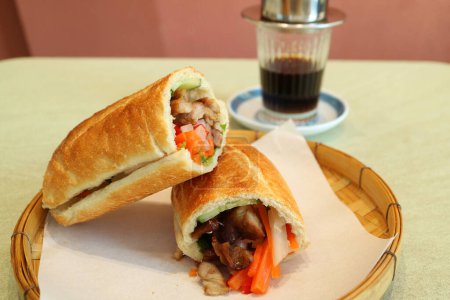 Photo for Mouthwatering Banh Mi with Vietnamese Drip Coffee in the Backdrop - Royalty Free Image