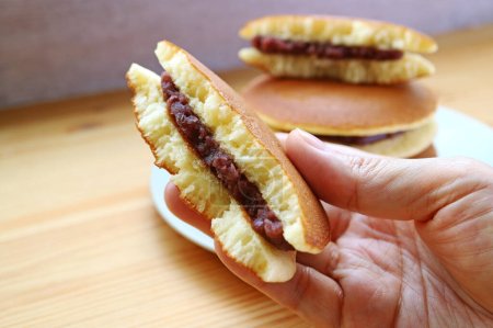 Hand Holding Delectable Split Dorayaki, a Famous Japanese Pancake