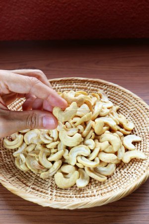 Hand Picking a Dried Cashew Nut Kernels from Its Pile