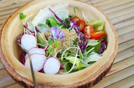Delectable Salad of Quinoa and Fresh Vegetables in a Wooden Bowl