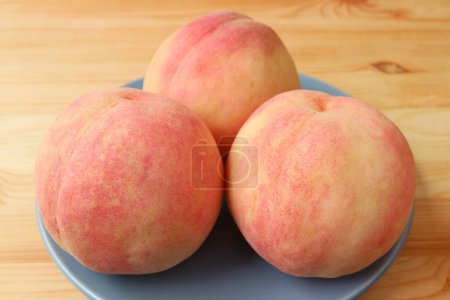 Closeup of Fresh Ripe Peaches on Wooden Table
