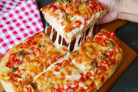Hand Picking a Slice of Freshly Baked Pizza Alla Pala with Mouthwatering Stretching Cheese