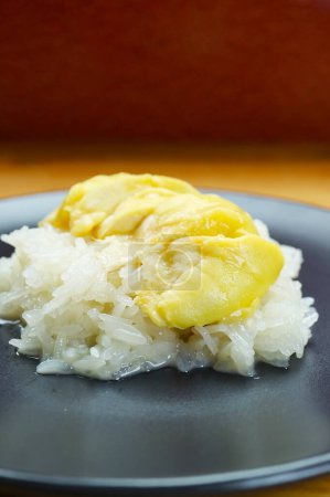 Plate of Popular Thai Dessert of Sticky Rice with Durian and Coconut Milk Called Kao Niaow Turian