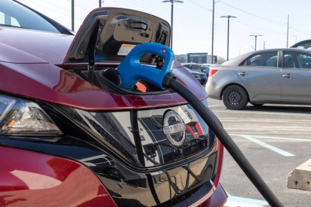Photo for Indianapolis - Circa December 2022: Nissan Leaf SV Plus electric vehicle at a charging station. The Leaf is part of the Nissan Zero Emission line. - Royalty Free Image