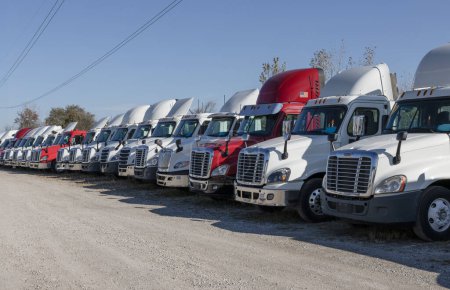 Photo for Indianapolis - November 2, 2023: Used Freightliner and International trucks for sale. Pre-owned semi tractor trailer trucks are in high demand. - Royalty Free Image