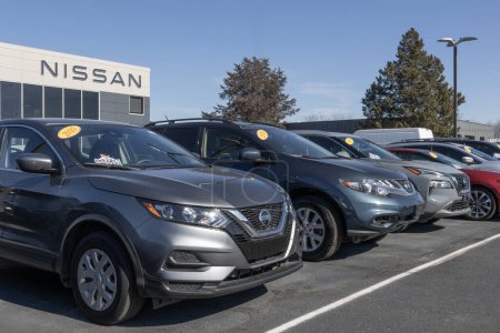 Photo for Indianapolis - February 11, 2024: Nissan Used Car display at a dealership. With supply issues, Nissan buys and sells pre-owned vehicles to meet demand. - Royalty Free Image
