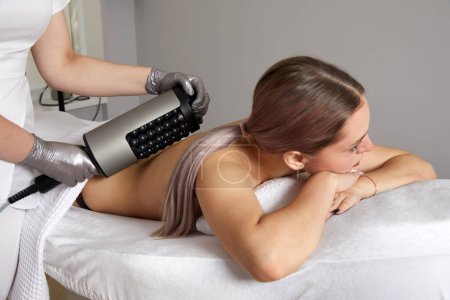 Endosphere therapy of female body by a cosmetologist in beauty salon