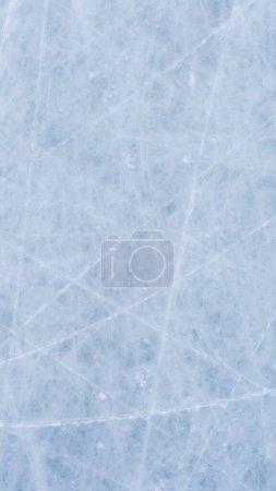 Ice background with marks from skating and hockey. blue texture