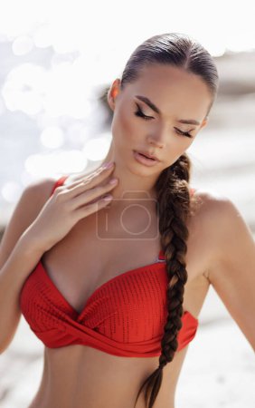 Photo for Fashion outdoor photo of beautiful woman with dark hair in elegant red swimming suit posing in the white stones beach in Cyprus - Royalty Free Image