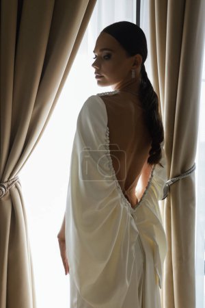 Photo for Fashion photo of beautiful bride in elegant wedding dress and accessories posing in elegant hotel room - Royalty Free Image