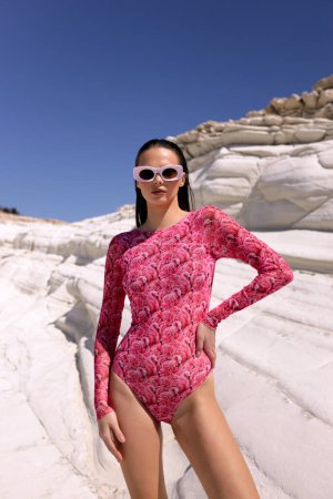 Photo for Fashion outdoor photo of beautiful sensual woman with dark hair in elegant printed beach clothes posing in the white rock beach on Cyprus - Royalty Free Image