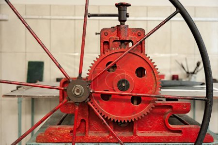 Red etching press for printmaking in etching studio closeup