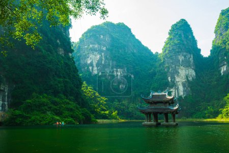 Photo for Temple on the lake, sorrounded by mountain at Trang An - Royalty Free Image