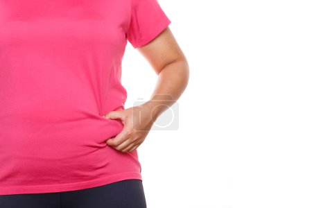 Photo for Woman touching his fat belly on white background. Woman hand holding excessive belly fat - Royalty Free Image
