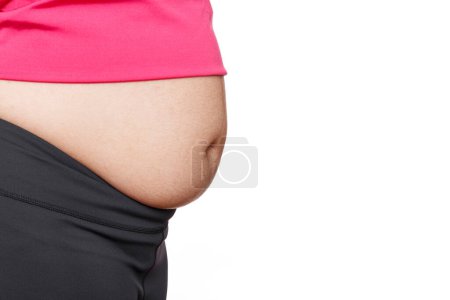 Foto de Woman with excessive belly fat against isolated on white background - Imagen libre de derechos