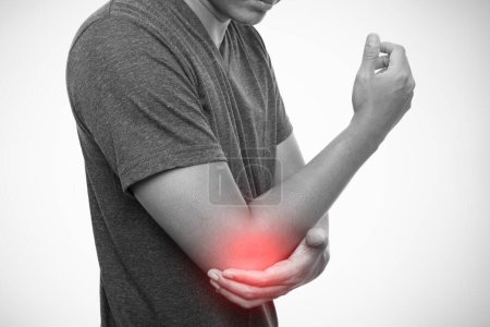 Man pain in the elbow isolated on gray background