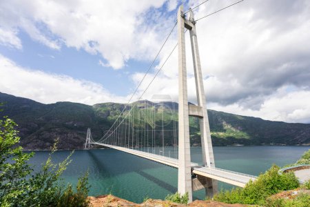 Photo for Hardanger Bridge is the longest suspension bridge in Norway. Hardangerbrua connecting two sides of Hardangerfjorden. Hardangerbrua bridge close to Ulvik in Western Norway - Royalty Free Image