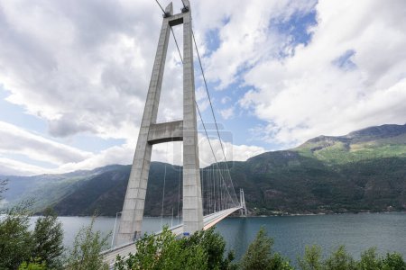 Photo for Hardanger Bridge is the longest suspension bridge in Norway. Hardangerbrua connecting two sides of Hardangerfjorden. Hardangerbrua bridge close to Ulvik in Western Norway - Royalty Free Image