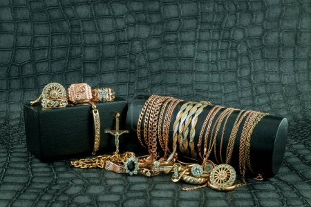 Photo for Old and broken scrap gold metal jewellery on black background - Royalty Free Image