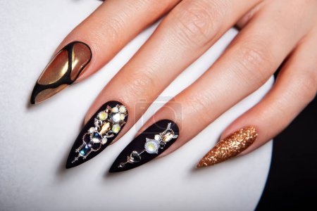 Photo for Black and gold manicure with diamonds. High-quality photo. - Royalty Free Image