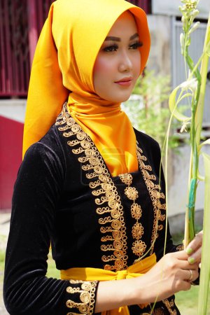 Photo for Indonesian with a traditional javanese cloth on 1800 chocolate ketupat cultural carnival festival (Kirab Budaya 1800 ketupat coklat) in Kampung coklat - Royalty Free Image